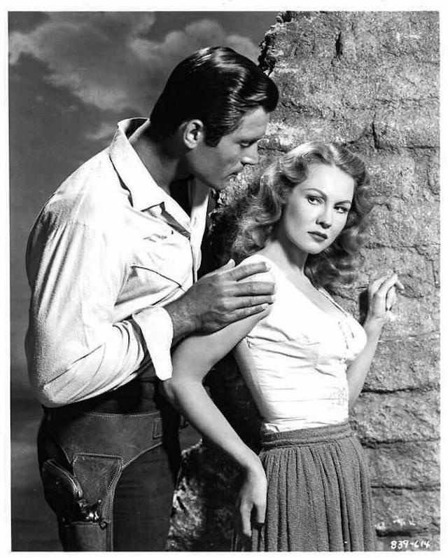 A scene of tension and suspense between Clint Walker and Virginia Mayo as they navigate the perils of the Wild West.